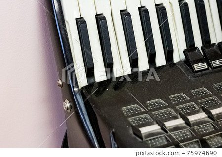 Keys of a black old accordion closeup 75974690