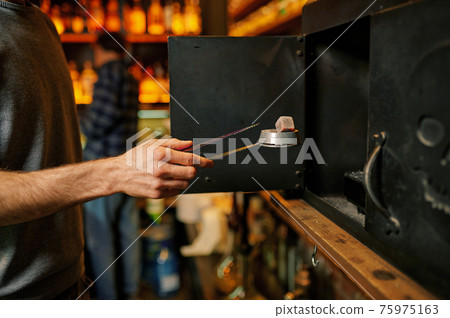 Male hookah maker, coal preparation in bar Male hookah maker, coal preparation in bar 75975163