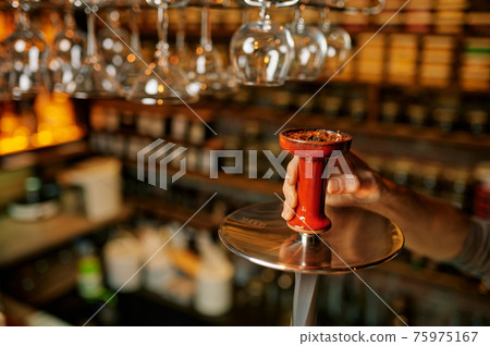 Hookah maker, smoking preparation in bar Hookah maker, smoking preparation in bar 75975167