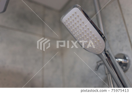 detail of a contemporary bath tub with luxury fixture. 75975413