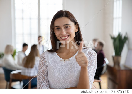 Portrait of smiling woman show thumb up recommend service Portrait of smiling woman show thumb up recommend service 75975568