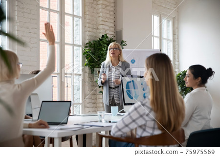 Female employee interact with businesswoman at meeting 75975569