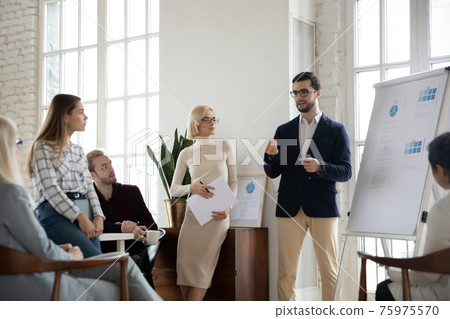 Male CEO present business project on whiteboard at meeting Male CEO present business project on whiteboard at meeting 75975570