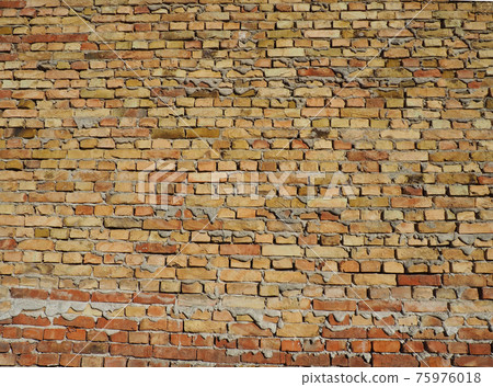 Brick wall of an old building. Cement between rows of bricks 75976018