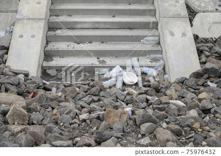 Plastic trash washed ashore Plastic trash washed ashore 75976432