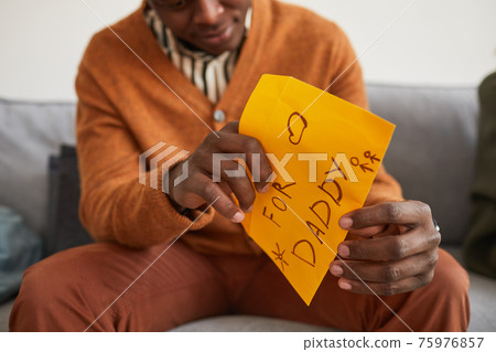 Man Opening Letter from Son Man Opening Letter from Son 75976857