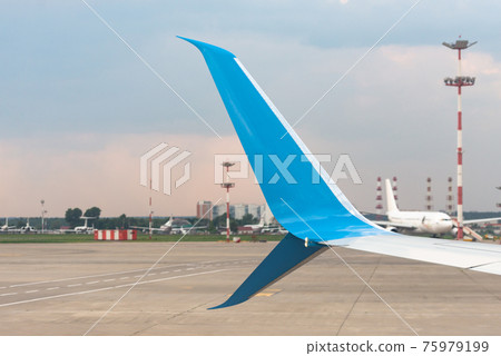 Vnukovo airport, Moscow. Blue wing tip. The wing of the aircraft on the background of taxiways at the airport. 75979199