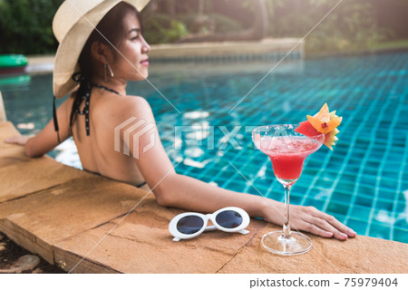 Young back woman in bikini swimming pool drink cocktail Young back woman in bikini swimming pool drink cocktail 75979404