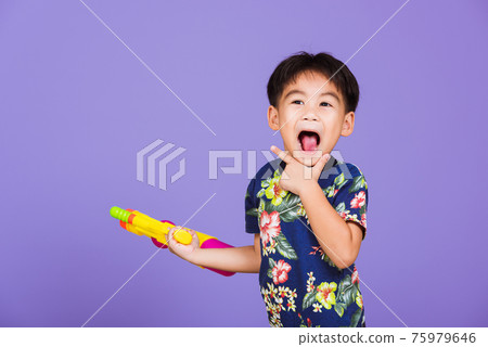 Thai kid funny hold toy water pistol and smiling 75979646