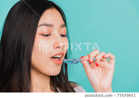 woman smiling wear putting silicone orthodontic retainers 75979651