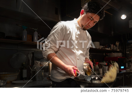 Cook cooking in the kitchen 75979745