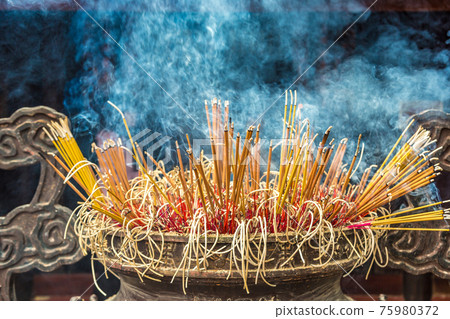 Burning incense sticks Burning incense sticks 75980372