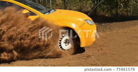 Rally race car drifting on dirt track. 75981579
