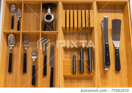 Top view of cutlery in a wooden box of a kitchen unit Top view of cutlery in a wooden box of a kitchen unit 75982650
