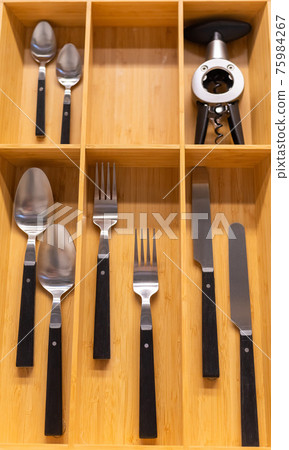 Top view of cutlery in a wooden box of a kitchen unit Top view of cutlery in a wooden box of a kitchen unit 75984267