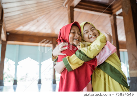 portrait asian kids girl Muslim laugh happiness and hug each other 75984549