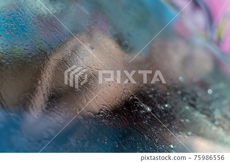 Nude woman driving a car. View from the fogged... - Stock Photo