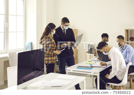 Boss chief and business team in face mask working together in new normal office Boss chief and business team in face mask working together in new normal office 75988022