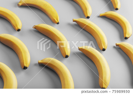 Geometric pattern of yellow bananas on a gray background in the Fashionable colors of 2021. Geometric pattern of yellow bananas on a gray background in the Fashionable colors of 2021. 75989930