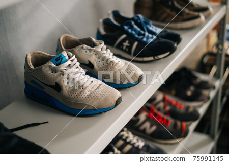Close-up top view of old various shoes on shelf before restoration in workshop, 75991145