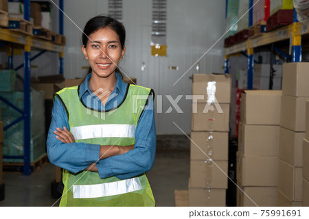 Portrait of young woman warehouse worker smiling in the storehouse 75991691