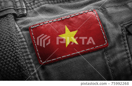 Tag on dark clothing in the form of the flag of the Vietnam Tag on dark clothing in the form of the flag of the Vietnam 75992268