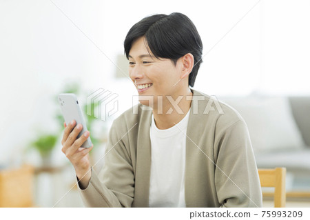 Men looking at smartphones Men looking at smartphones 75993209