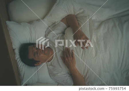 A middle-aged man who can't sleep because he is looking forward to tomorrow 75993754