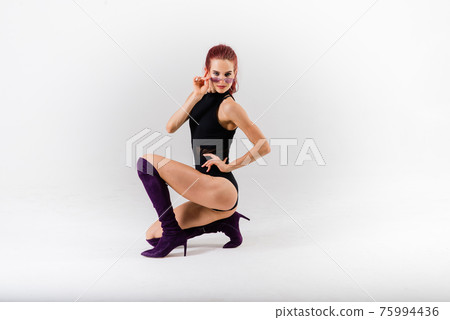Sexy pole redhead dancer showing her body. Sexy pole redhead dancer showing her body. 75994436