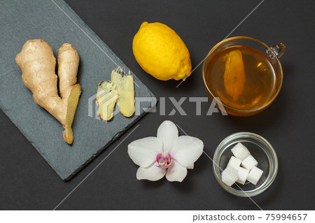Health remedy foods for cold and flu relief on a black background. Health remedy foods for cold and flu relief on a black background. 75994657
