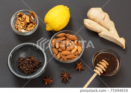 Health remedy foods for cold and flu relief on a black background. 75994658