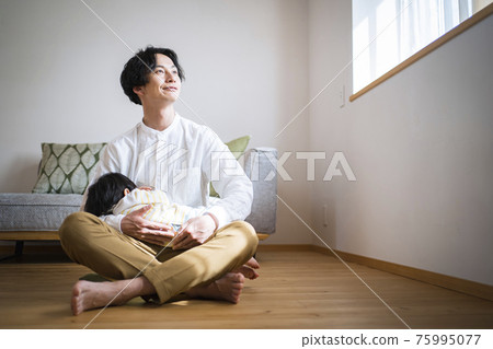 Father in his thirties interacting with his one-year-old son 75995077