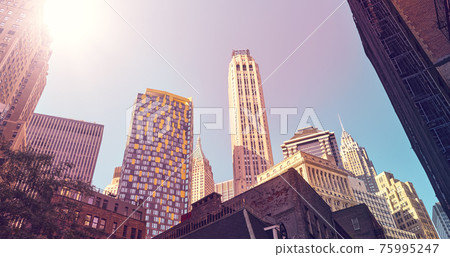Looking up at Manhattan buildings, color toned picture, New York City, USA. 75995247