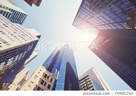 Looking up at New York skyscrapers, color toned picture, USA. Looking up at New York skyscrapers, color toned picture, USA. 75995250