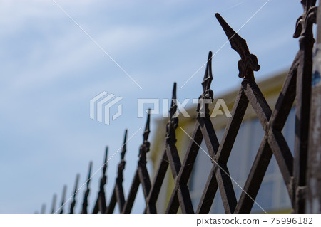 close-up of metallic fence with one bent spoke close-up of metallic fence with one bent spoke 75996182