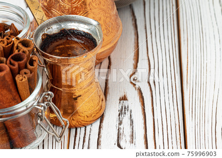 Coffee in metal turk with spices in a plate 75996903