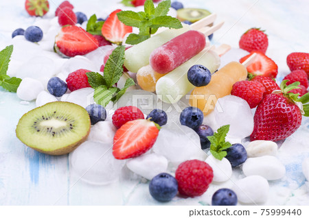 Healthy Whole Fruit Popsicles with Berries Kiwi strawberries on light background Healthy Whole Fruit Popsicles with Berries Kiwi strawberries on light background 75999440