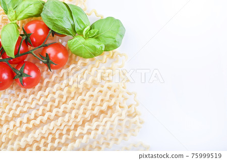 Pasta with fresh tomatoes, basil and olive oil on light shabby rustic background, top view, border 75999519