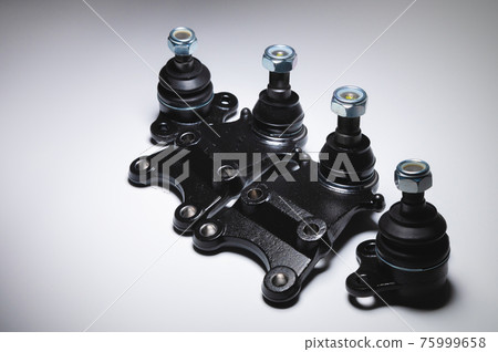A set of new off-road car suspension ball joints. New auto parts on a gradient gray background A set of new off-road car suspension ball joints. New auto parts on a gradient gray background 75999658