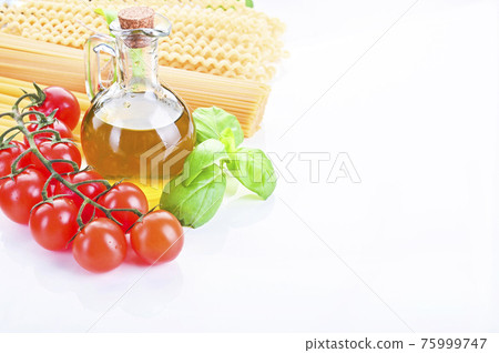 Pasta with fresh tomatoes, basil and olive oil on light shabby rustic background, top view, border Pasta with fresh tomatoes, basil and olive oil on light shabby rustic background, top view, border 75999747
