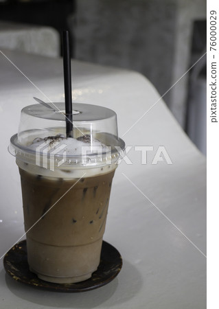 A glass of iced coffee latte with art 76000029