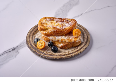 Homemade traditional Spanish torrijas or French toast with kumquats and blueberries Homemade traditional Spanish torrijas or French toast with kumquats and blueberries 76000977