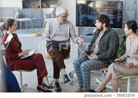 Senior Man Heading Meeting in Circle 76001059