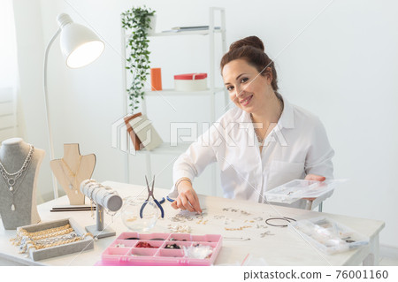 Professional jewelry designer making handmade jewelry in studio workshop. Fashion, creativity and handmade concept Professional jewelry designer making handmade jewelry in studio workshop. Fashion, creativity and handmade concept 76001160