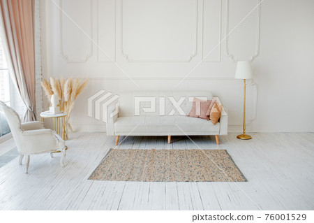 Stylish Scandinavian modern white cozy eco interior in minimalist style. Modern home decor with Pampas grass in vase. Open space. Monochrome, copy space 76001529