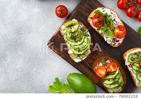 Assortment of vegan sandwiches with avocado and tomatoes Assortment of vegan sandwiches with avocado and tomatoes 76002228