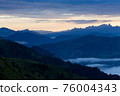 Early morning in the mountains. The sun rises over the mountains. Dawn in the mountains. 76004343