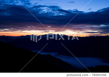 Early morning in the mountains. The sun rises over the mountains. Dawn in the mountains. 76004346