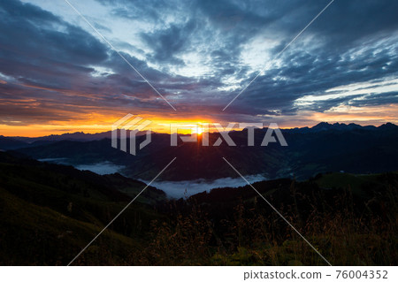 Early morning in the mountains. The sun rises over the mountains. Dawn in the mountains. 76004352