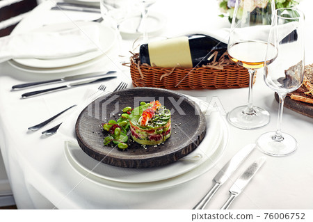 Salad of avokado, seafood, meat, vegetables and pumpkin seeds. Dietary, wholesome and tasty. Banquet festive dishes. Gourmet restaurant menu. White background. 76006752